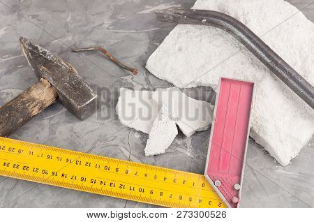 Broken Stone And Dirty Old Hammer With Wooden Handle And Rust Nail And Metal Nail Puller And Yellow 