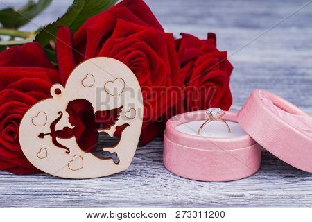 Romantic Background With Roses And Golden Ring. Engagement Ring In Box, Red Roses And Wooden Heart. 