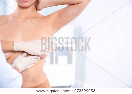 Doctor Checking Woman's Breast At Hospital, Closeup. Space For Text