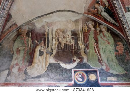 BRESSANONE, ITALY - JULY 14, 2018: Virgin Mary with baby Jesus and Saints, fresco in the cloister, Cathedral of Santa Maria Assunta and San Cassiano in Bressanone, Italy