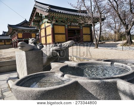 Small Stone Fountain And Traditional Asian Houses On The Background In Naksansa Temple, Yangyang Cit