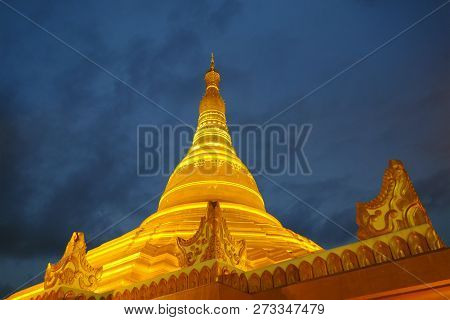 Golden Color Uppatasanti Pagoda In Nay Pyi Taw Capital City, Myanmar On Dark Blue Cloudy Sky