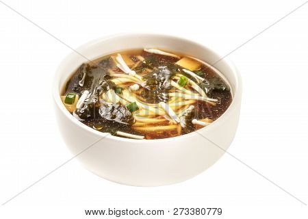 A Photo Of A Bowl Of Miso Soup With Tofu, Scallions, Noodles, Wakame, And Enoki Mushrooms, Isolated 