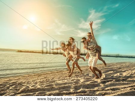 Happiness Friends fun on the beach under sunset sunlight in summer suny day.