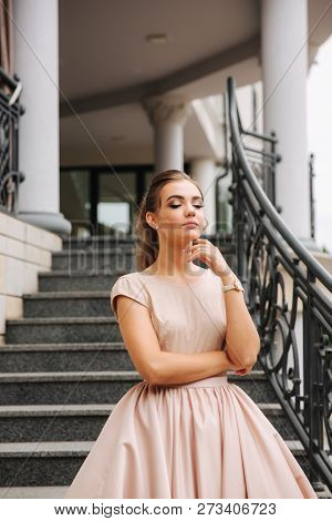 Elegant Lady Satnd On Stairs In Front Of Restaurant