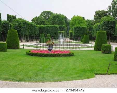 Abstract Ideal Flower Beds And Shorn Trees In A Well-kept Park