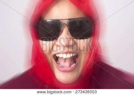 Portrait Of Muslim Lady Wearing Black Sunglasses In Red Suit And Hijab Laughing Hard, Bully Expressi