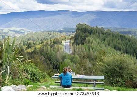 Tasman District New Zealand - October 5 2018; Two Young Tourists Stop For A Meal At Roadside Layby T