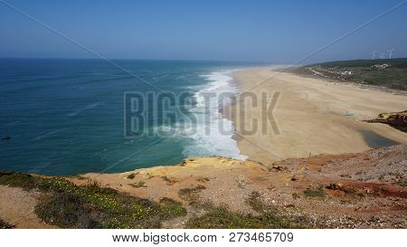 Rough Waves Touching Coast At Nazare In Portugal