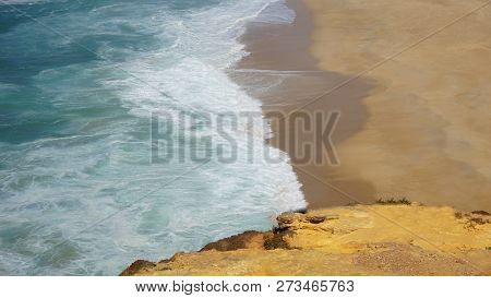 Rough Waves Touching Coast At Nazare In Portugal