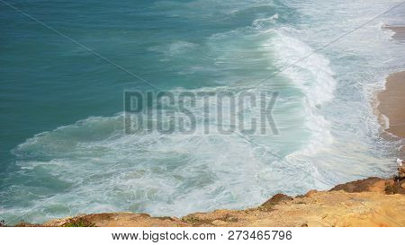 Rough Waves Touching Coast At Nazare In Portugal