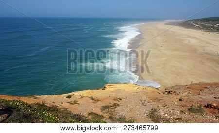 Rough Waves Touching Coast At Nazare In Portugal