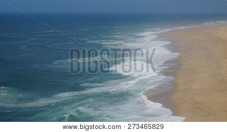 Rough Waves Touching Coast At Nazare In Portugal