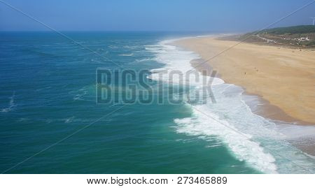 Rough Waves Touching Coast At Nazare In Portugal