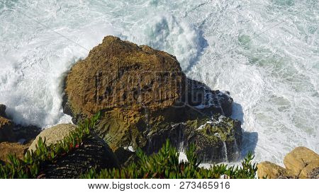 Rough Waves Touching Coast At Nazare In Portugal