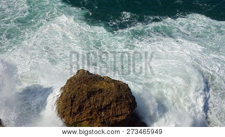 Rough Waves Touching Coast At Nazare In Portugal
