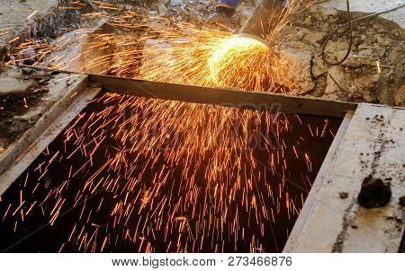 Cutting Metal Reinforcement In Reinforced Concrete. Sparks From Friction With Metal. Disassembly Wor