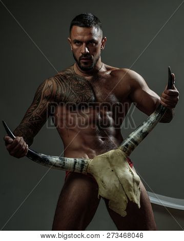 Treason. Brutal Men With Horns. Treason And Resentment. Resentment Of Bearded Man After Treason With