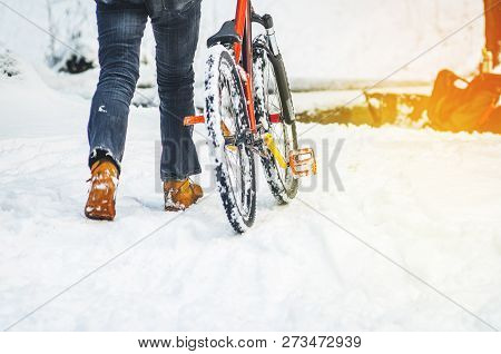 Men Rider Pushes The Extreme Mountain Bike In The Winter Snow-covered Forest. Abstract Extreme Sport