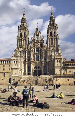 Santiago de Compostela, Spain; November 14 2018: Pilgrims looking at Santiago de Compostela Cathedral in Obradoiro square