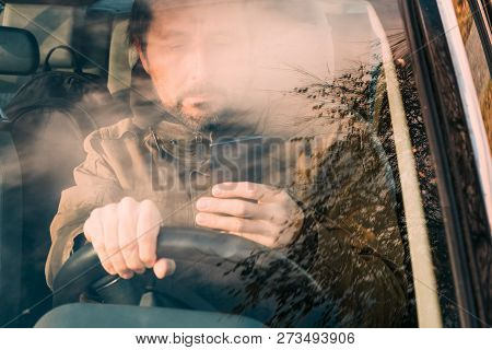 Front View Of Man Driving Car And Texting On Mobile Phone Which Is Dangerous And Reckless Behavior