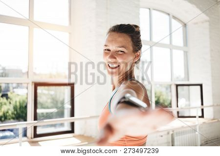 Portrait Of Handsome Happy Woman Practice Yoga Exercises Indoor Sunny Loft Gym. Toned Color. Slim Ta