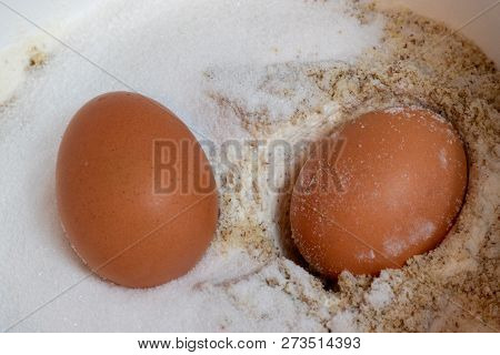 Flour And Two Brown Egg In Bowl