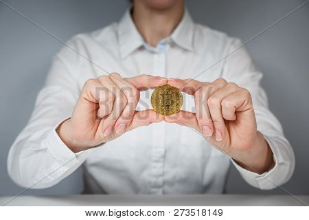 Golden Bitcoin In A Man Hand, Digitall Symbol Of A New Virtual Currency