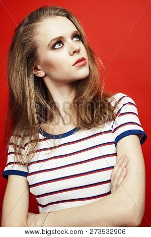 Young Pretty Teenage Girl On Bright Red Background, Happy Smilin