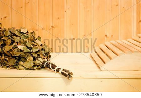 Russian Or Finnish Sauna Broom And Headrest In Wooden Sauna. Steam Bath With Broom Hot Steam
