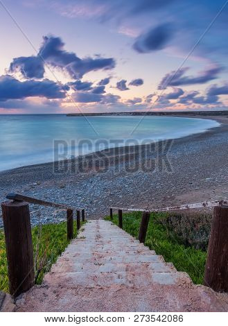 Wooden Path Down To The Beach And Ocean. Walkway And Stairs Through Sand Dunes And Grass.