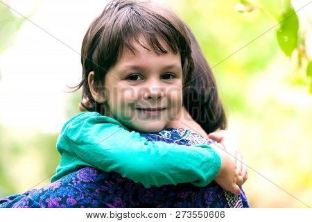 The Boy Is Hugging His Mother.