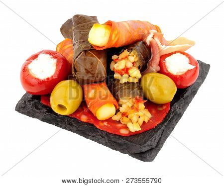 Group Of Tapas Snacks On A Slate Square Isolated On A White Background