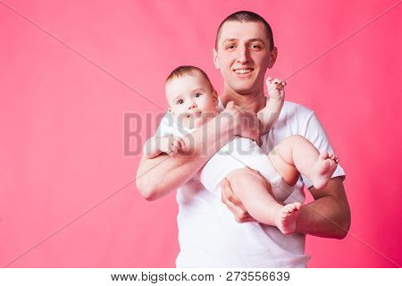 Faher And Baby Portrait On A Pink Background