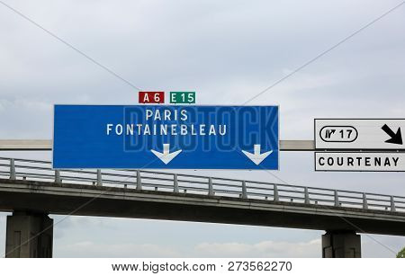 Blue Motorway Sign With Directions To Paris And Fontainebleau