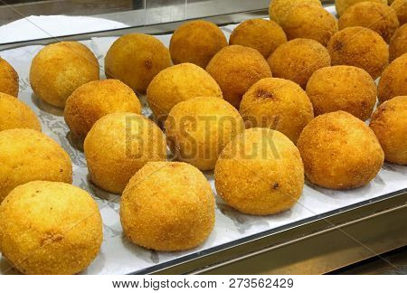 Typical Fried Sicilian Arancini Stuffed With Mozzarella And Tomato For Sale In A Shop Selling Typica