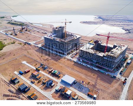 Aerial View Of A Construction Crane Tower. Top View Crane And Building Working Progress. Worker. Con