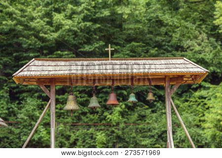 The Image Of Church Bells Under A Canopy In The Courtyard Of The Church