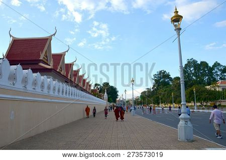 Phnom Penh, Cambodia - December 11, 2015: Monks, Tourists And Local People Walk Along The Street Nea