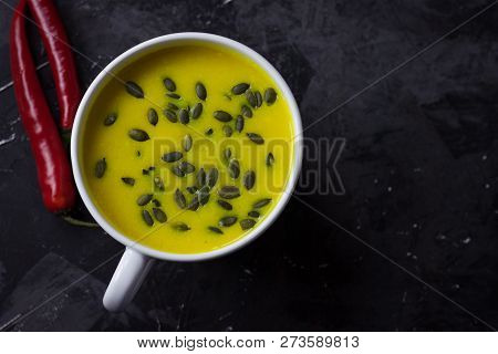 Pumpkin Asian Coconat Cream Soup. Autumn Hot Food. Chili Pepper, Garlic, Red Onion, Big Pumpkin. Dar