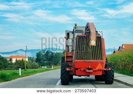 Agricultural Tractor On The Highway Road In Slovenia.