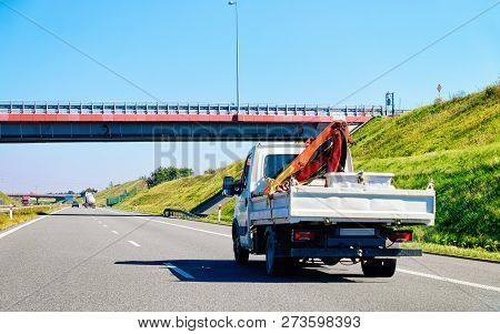 Truck Carrying Trailer With Crane At The Asphalt Road In Slovenia.