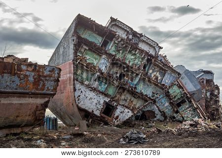 Huge Rusty Pieces Of Decommissioned Marine Ship That Was Cut And Left On The Shore.