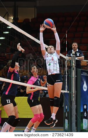 KAPOSVAR, HUNGARY â DECEMBER 2, 2018: Viktoria Kalmar posts ball at a Hungarian National Championship volleyball game between Kaposvar (white) and Palota VSN (blue) in Sportcsarnok Kaposvar.