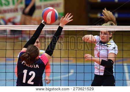 KAPOSVAR, HUNGARY â DECEMBER 2, 2018: Evelin Vacsi (white 6) in action at a Hungarian National Championship volleyball game between Kaposvar (white) and Palota VSN (blue) in Sportcsarnok Kaposvar.