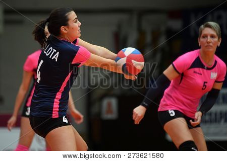 KAPOSVAR, HUNGARY â DECEMBER 2, 2018: Gabriella Benedek (with ball) in action at a Hungarian National Championship volleyball game between Kaposvar (white) and Palota VSN (blue) in Sportcsarnok Kaposv
