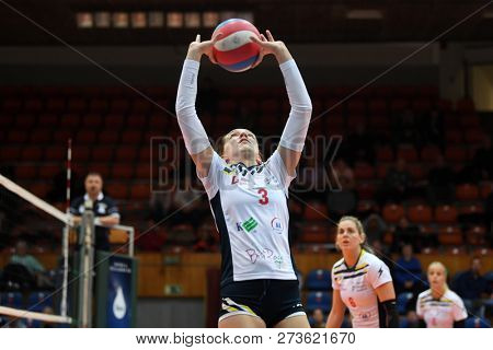 KAPOSVAR, HUNGARY â DECEMBER 2, 2018: Viktoria Kalmar posts ball at a Hungarian National Championship volleyball game between Kaposvar (white) and Palota VSN (blue) in Sportcsarnok Kaposvar.