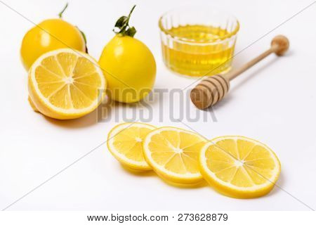 Slace Of Fresh Ripe Lemon And Wooden Honey Dipper On White Background Honey Horizontal