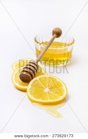 Slace Of Fresh Ripe Lemon And Wooden Honey Dipper On White Background Honey Vertical