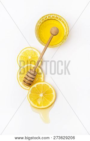 Slace Of Fresh Ripe Lemon And Wooden Honey Dipper On White Background Honey Vertical Top View